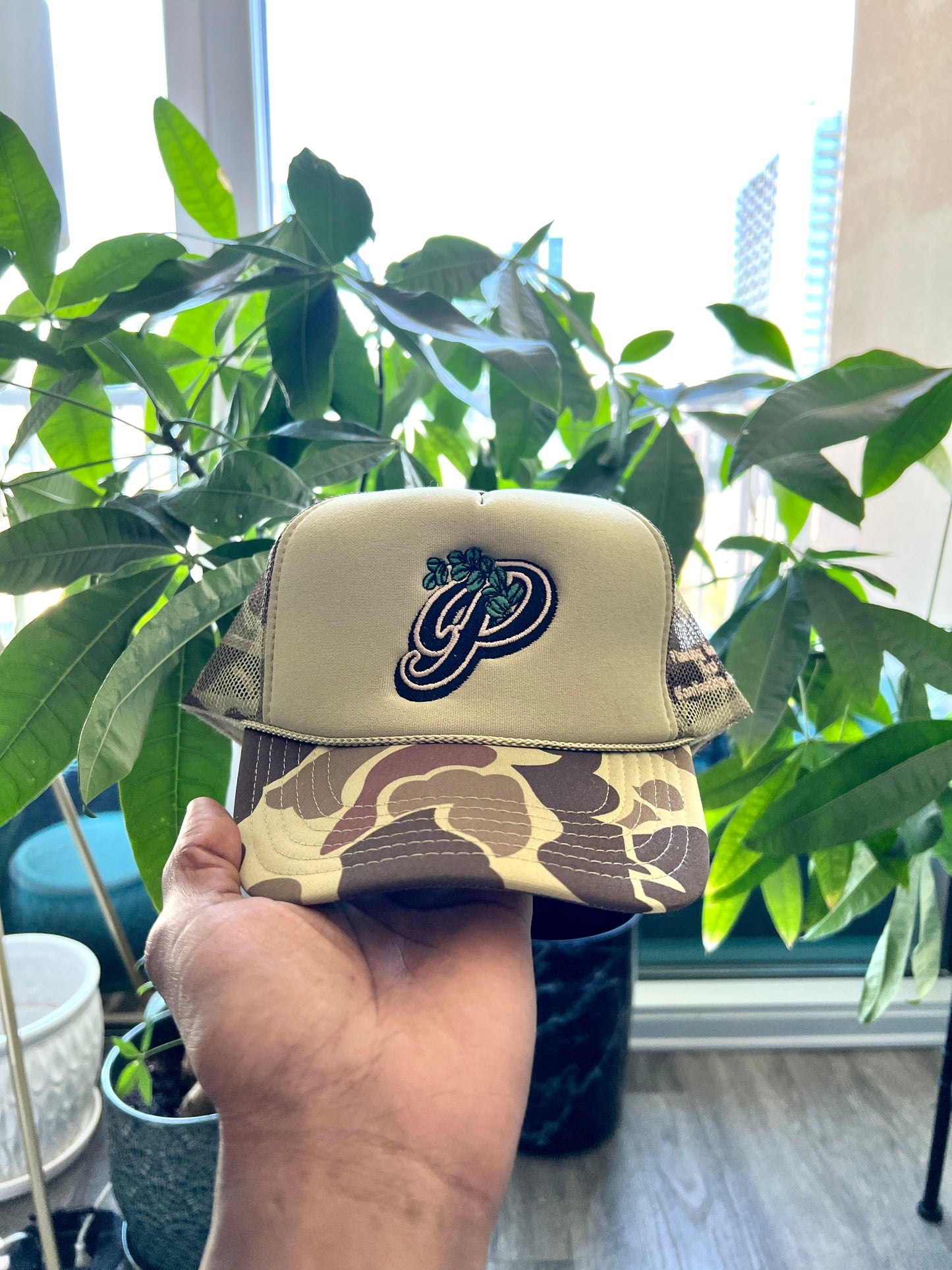 PLVNTD P Trucker hat